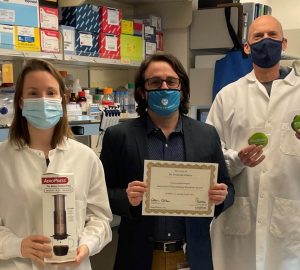 Photo of award recipients with AeroPress and Certificate and cookies.
